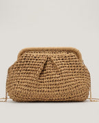 Camel straw shell bag detail showing weave texture and brass lock clasp