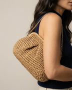Wildfool woven straw crossbody in camel with brass chain strap — front view