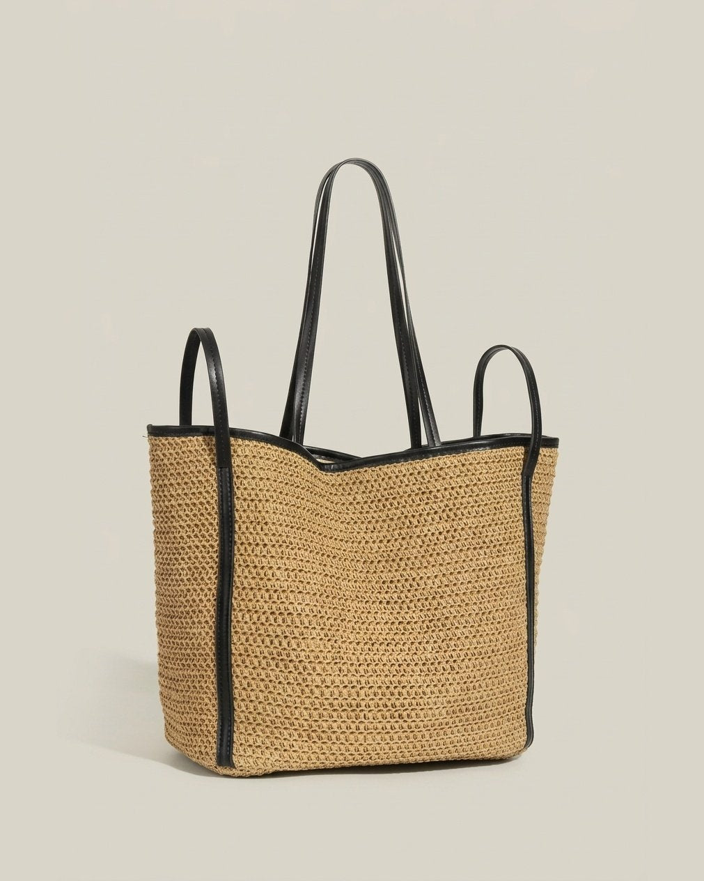 Brown woven grass tote showing interior lining and drawstring closure