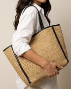 Large brown straw tote with laptop inside — capacity demonstration