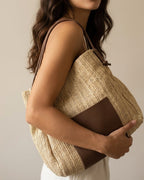 Black straw tote with drawstring handles — side angle showing weave texture