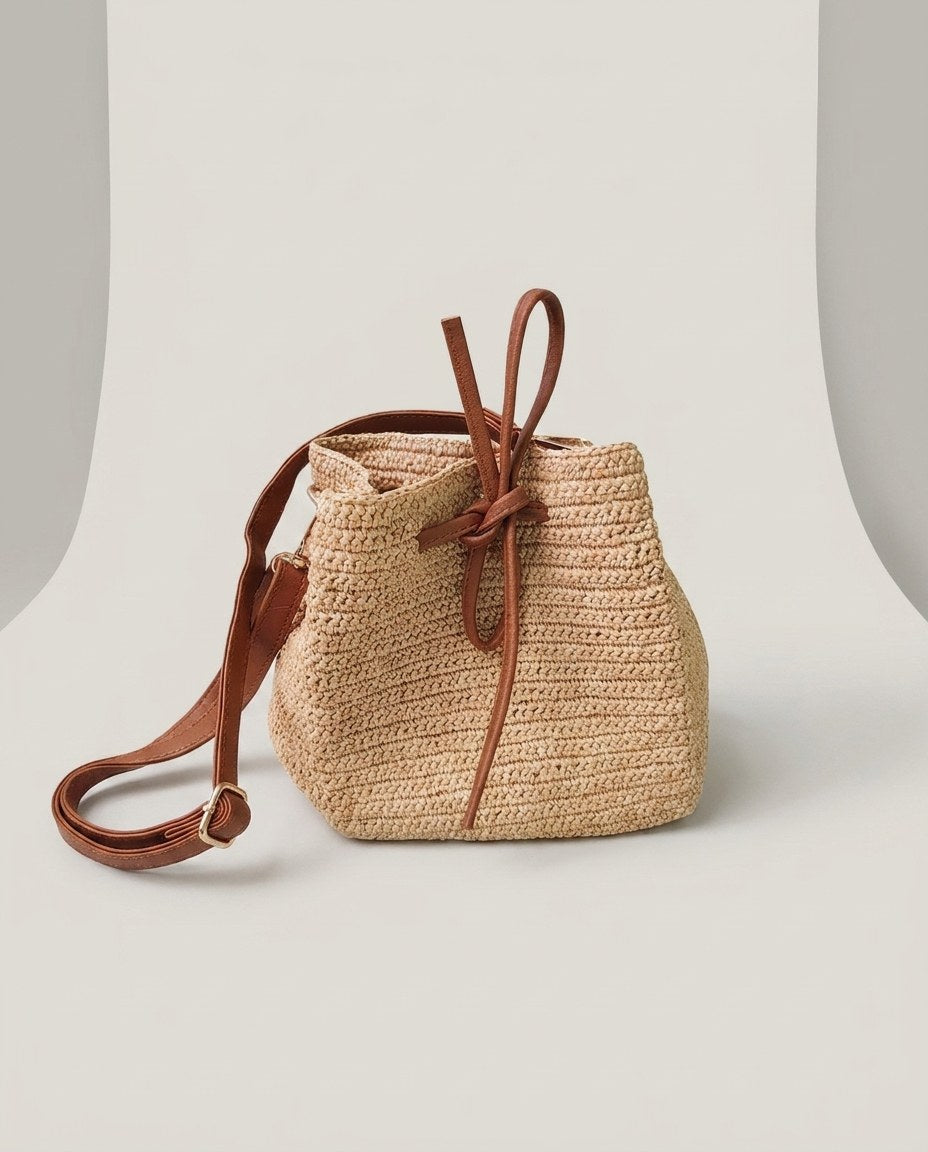 Wildfool The Noto Raffia Bucket in Natural — hand-woven raffia bucket bag with leather tie and cowhide strap