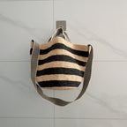 Wildfool The Taormina Raffia Tote — detail view, black-and-cream herringbone webbing strap