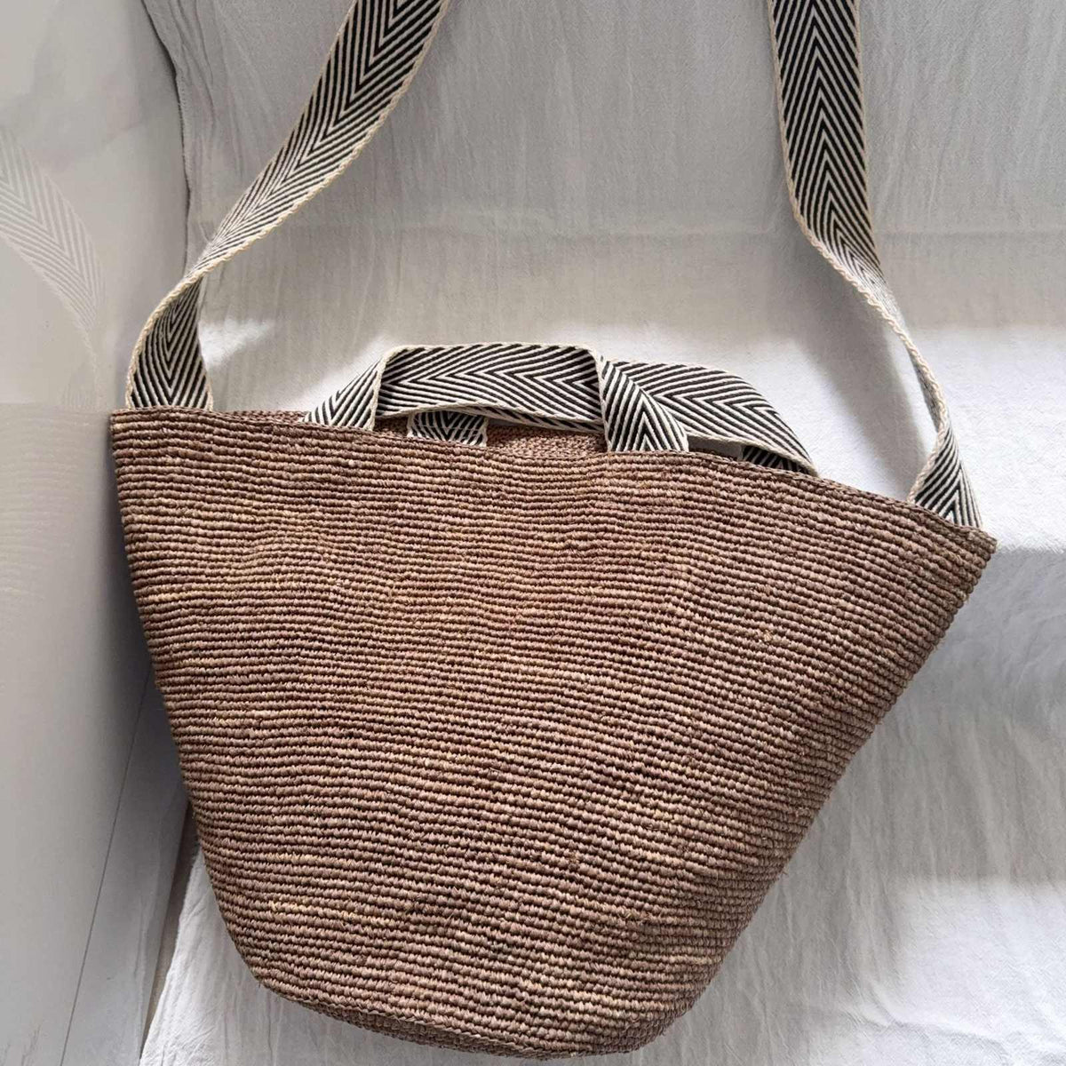 Wildfool The Taormina Raffia Tote — detail view, black-and-cream herringbone webbing strap