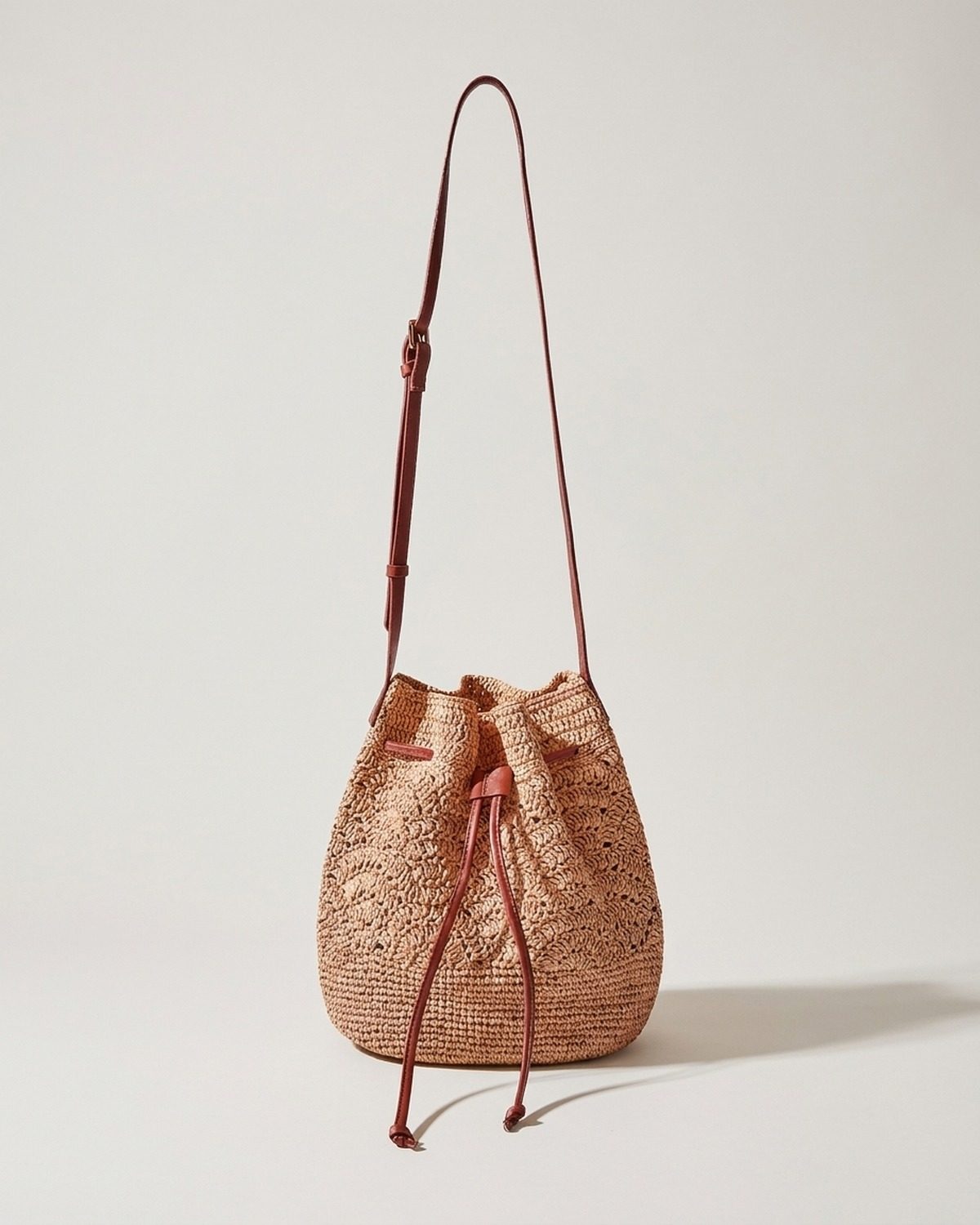 Wildfool The Bari Crochet Bucket in Khaki — hand-crocheted paper straw bucket bag with drawstring