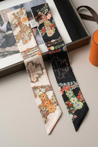 Wildfool mulberry silk twilly in red brick with white carriage drawings — flat lay on linen