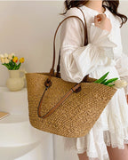 Cream basket tote styled with linen shirt — lifestyle flat lay with produce and novel
