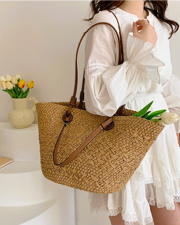 Cream basket tote styled with linen shirt — lifestyle flat lay with produce and novel
