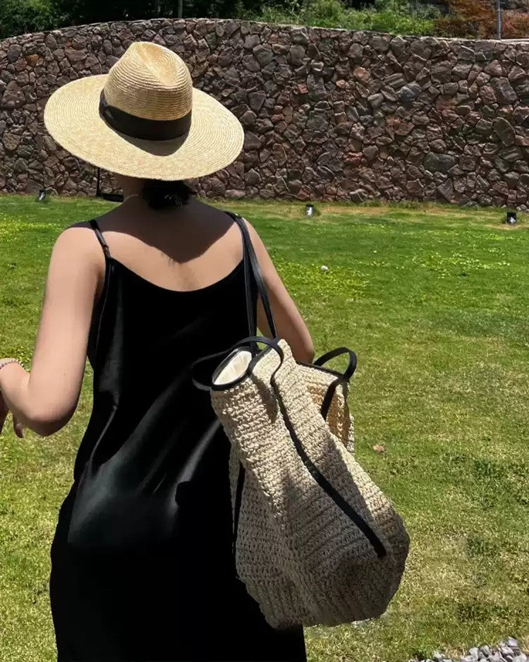 Brown woven tote detail — buckle and drawstring closure mechanisms