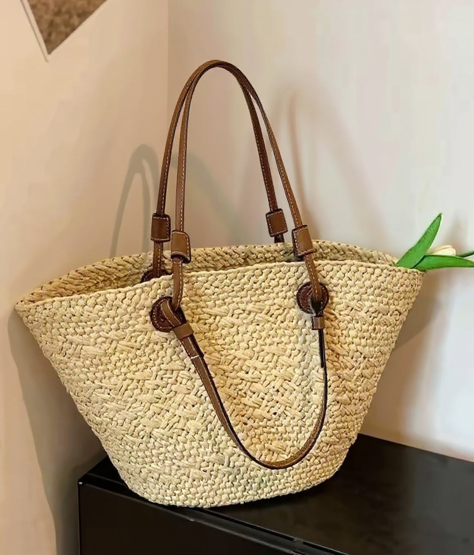 Cream basket tote styled with linen shirt — lifestyle flat lay with produce and novel