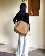 Brown woven tote detail — buckle and drawstring closure mechanisms