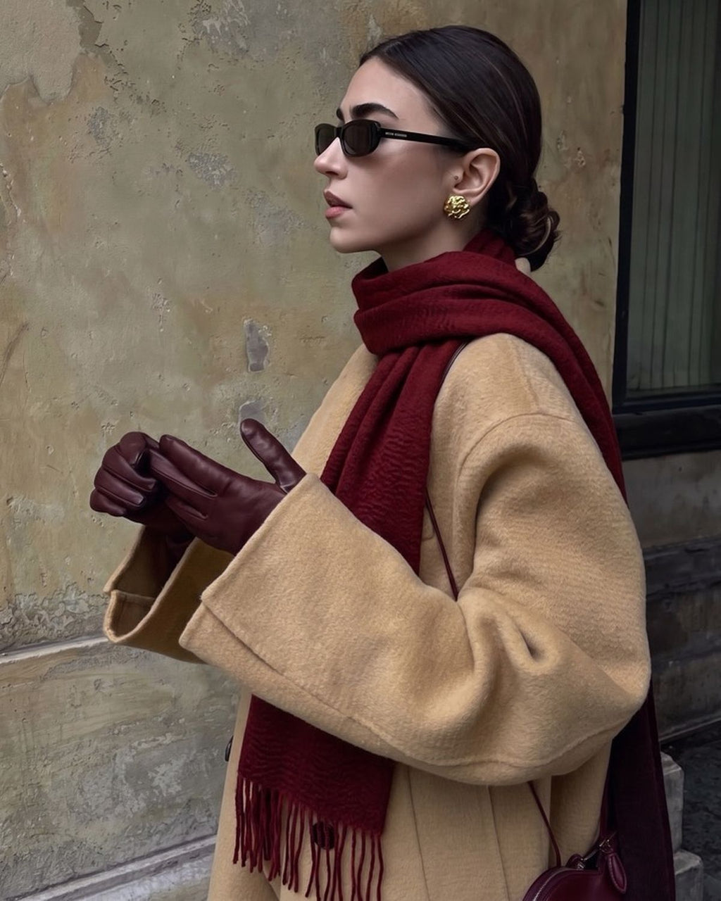 The Dune 100% Cashmere Scarf in Burgundy, worn with a camel coat