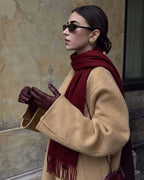 The Dune 100% Cashmere Scarf in Burgundy, worn with a camel coat