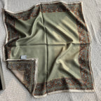 Close-up of deep brown and olive-green paisley kashmir border detail on Wildfool scarf