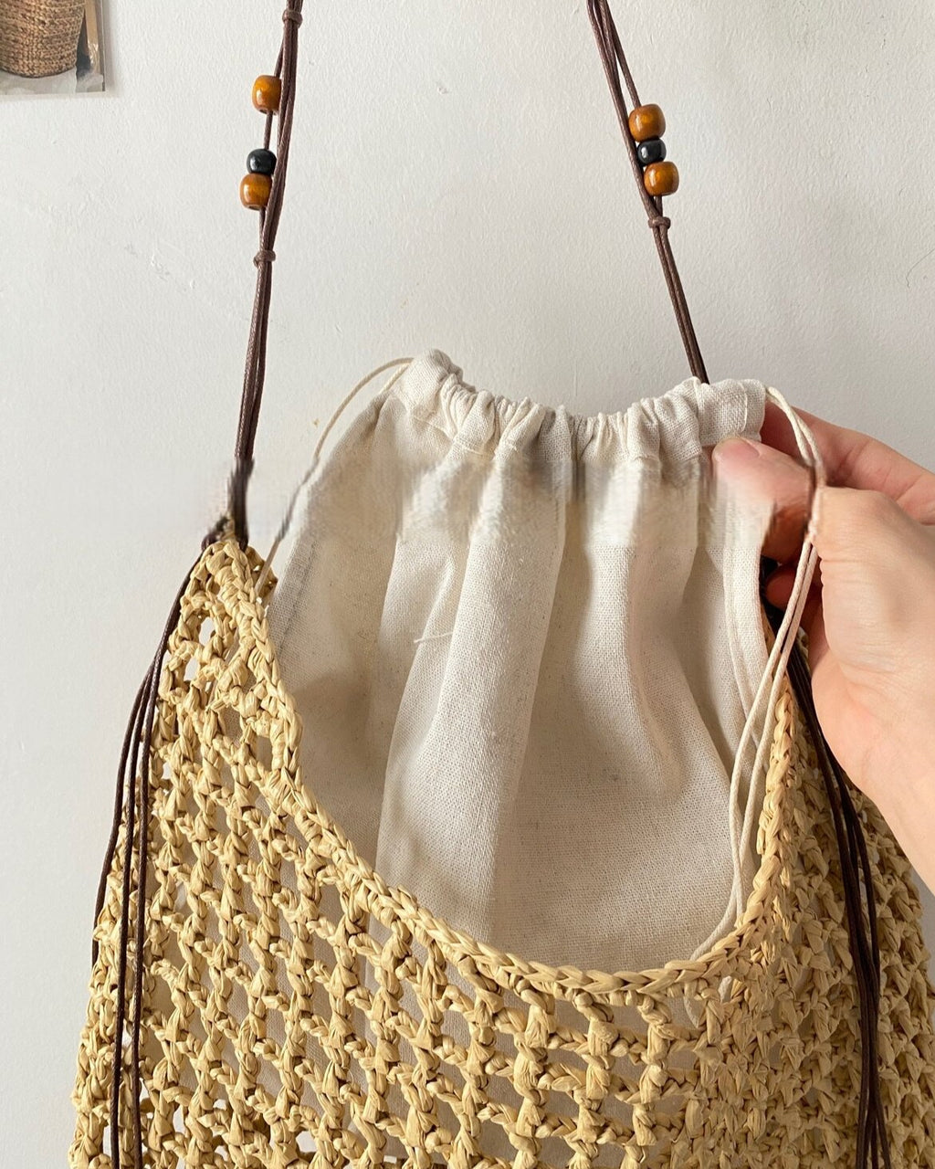 Wildfool Beaded Grass Tote in Black — three-quarter view, strap over shoulder