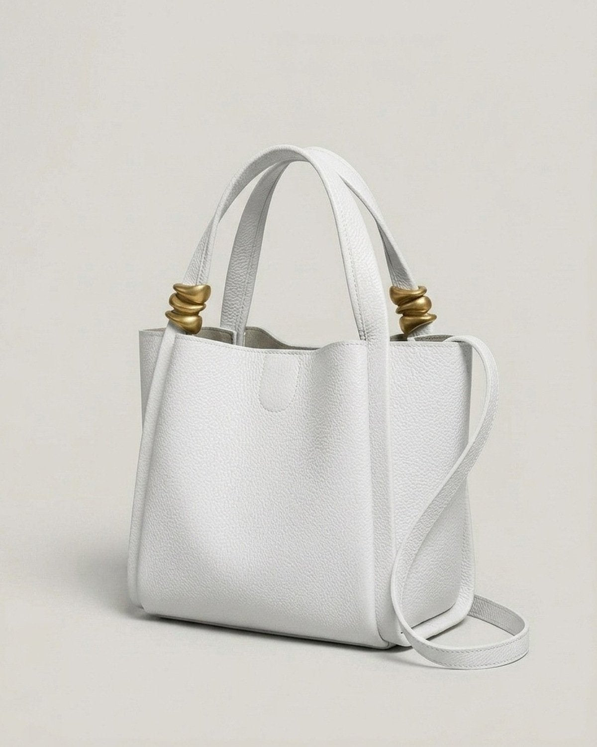 The Tivoli Bucket Bag in Chalk White, three-quarter angle view