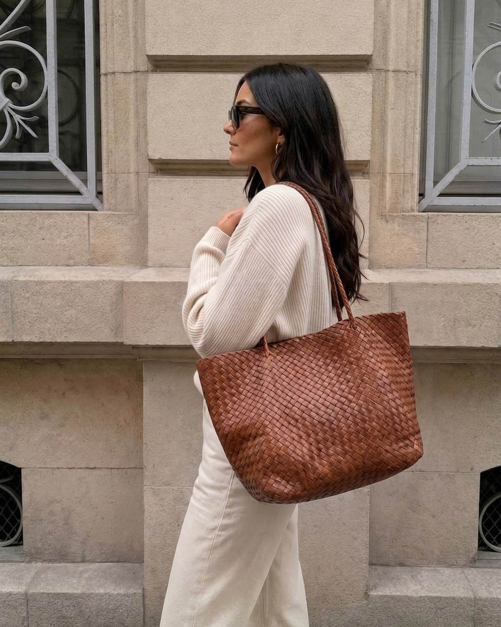 The Heritage Woven Leather Tote in Espresso, carried on the shoulder