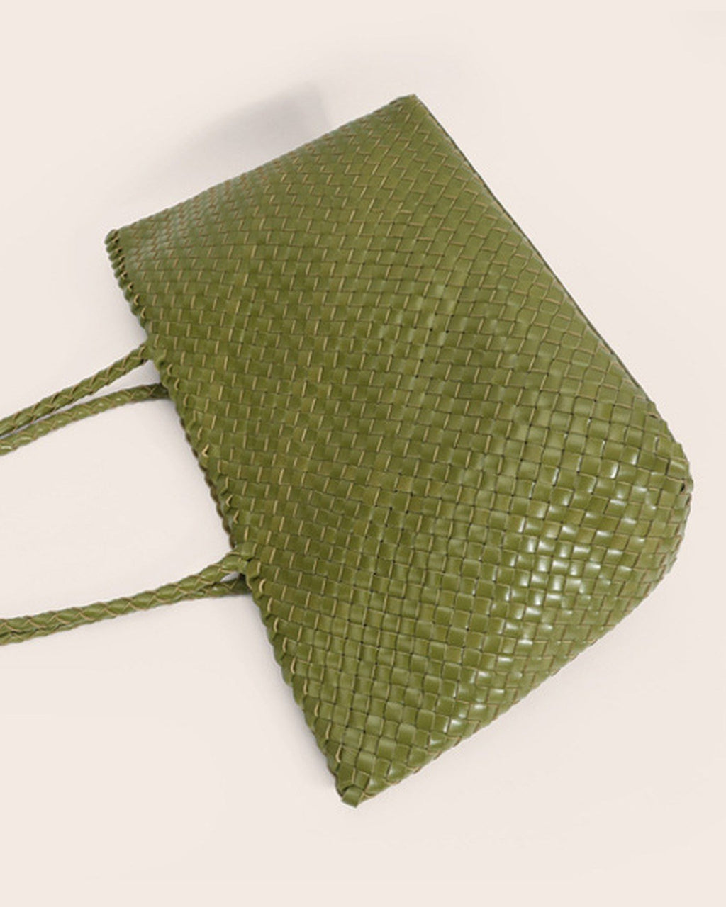 The Heritage Woven Leather Tote in Olive, on its side