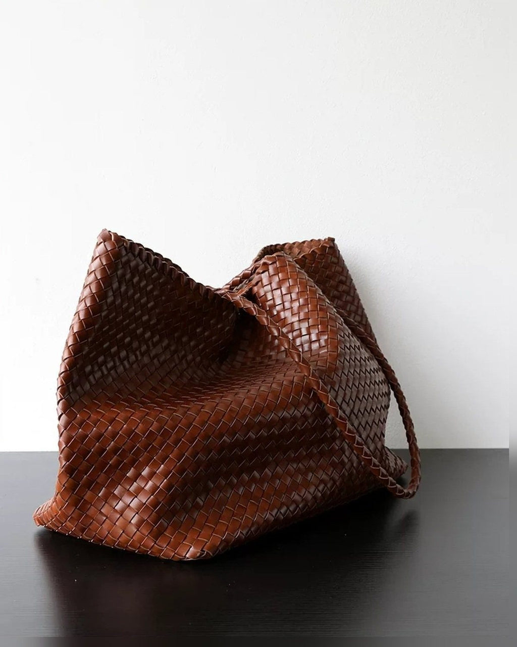 The Heritage Woven Leather Tote in Espresso, slouched side view
