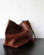 The Heritage Woven Leather Tote in Espresso, slouched side view