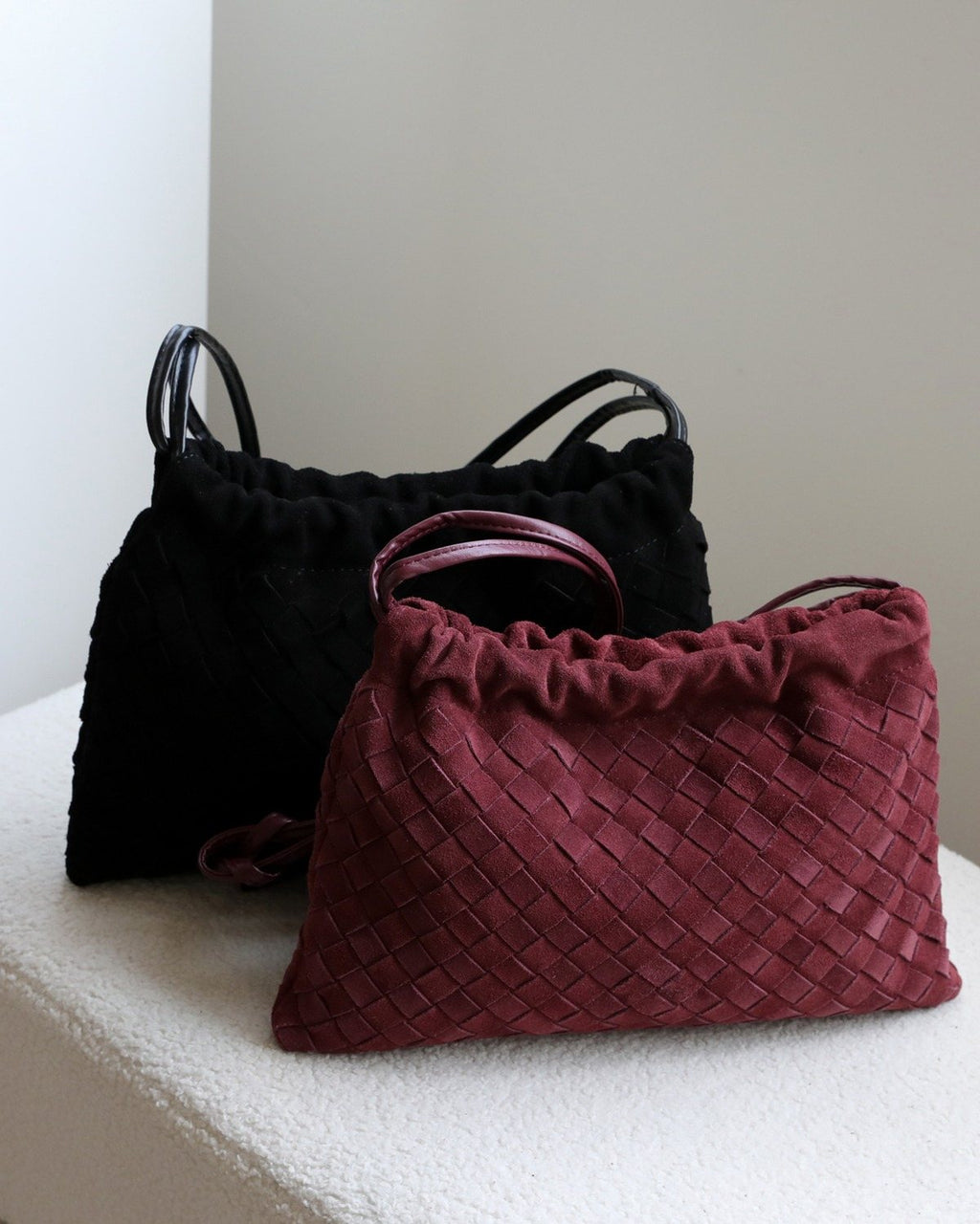 Wildfool The Mantova Drawstring Pouch in Black and Burgundy, side by side