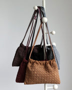 Wildfool The Mantova Drawstring Pouch, all five colours hanging on a coat stand