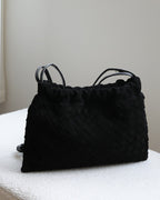 Wildfool The Mantova Drawstring Pouch in Black, on a stone plinth