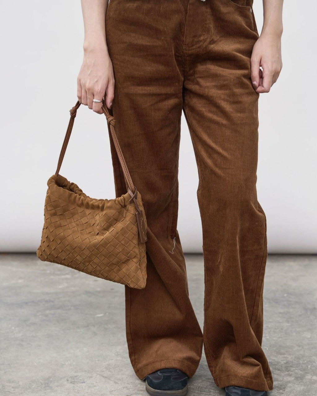Wildfool The Mantova Drawstring Pouch in Caramel, carried by hand
