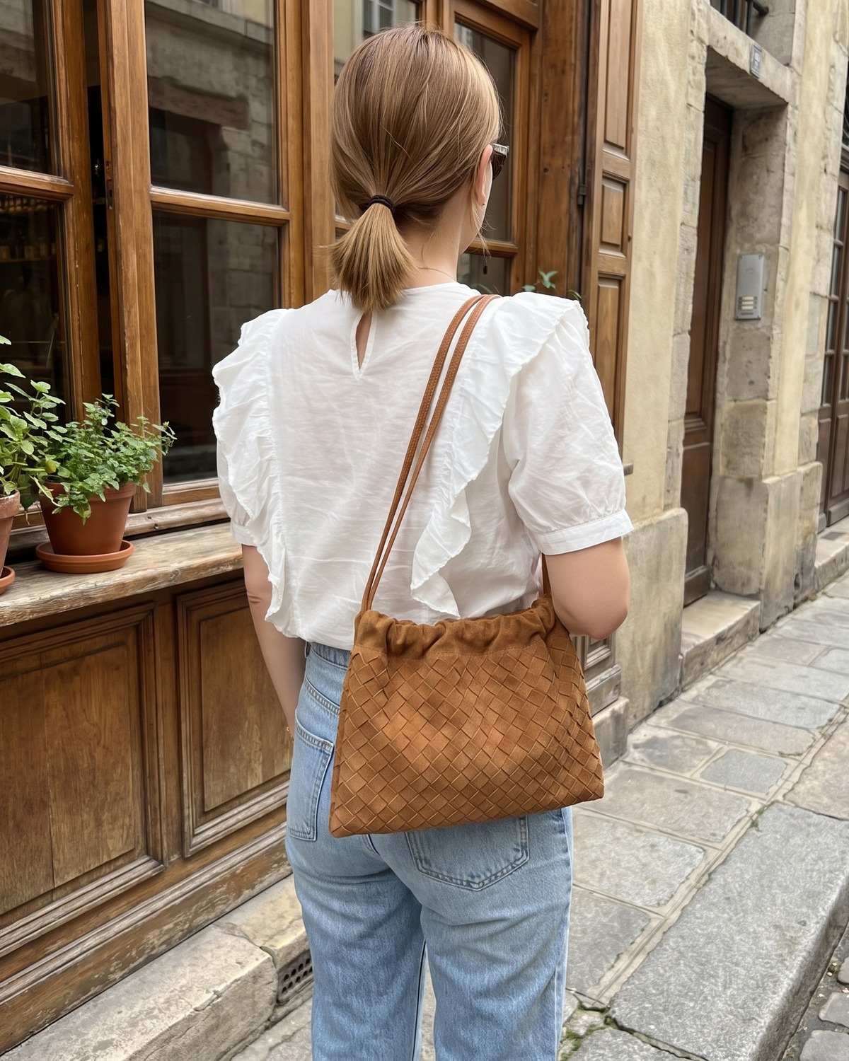 Wildfool The Mantova Drawstring Pouch in Caramel, worn on the shoulder