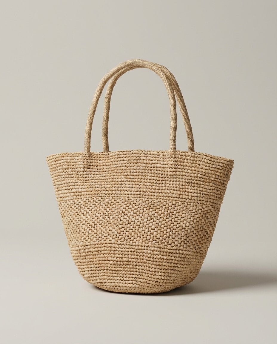 Wildfool The Hand-Woven Raffia Market Tote — worn at the shoulder, styled with linen