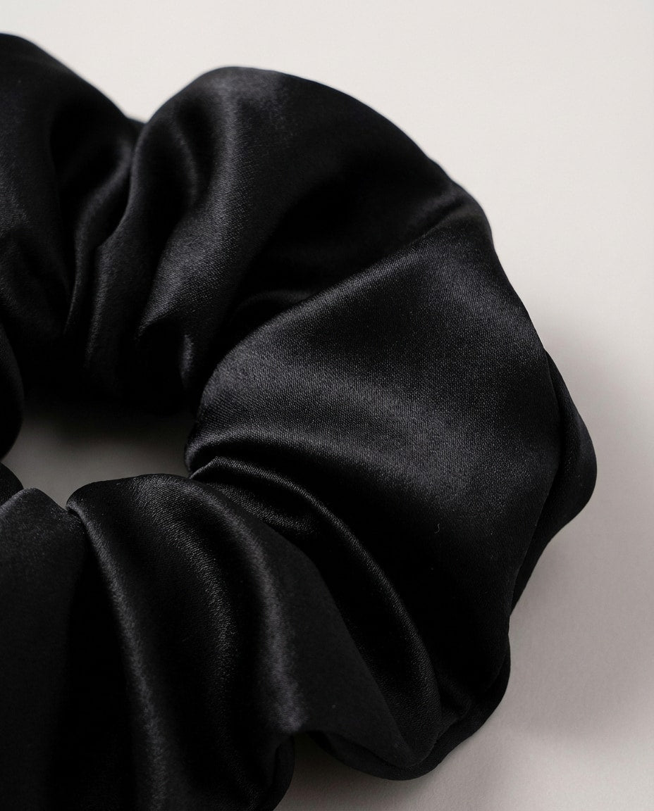 Mulberry silk scrunchie folded inside its small drawstring pouch