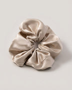 30-momme silk scrunchie set in three colors — champagne, blush, ink — arranged in a row
