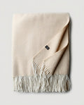 Macro close-up of the herringbone weave on cashmere-blend throw