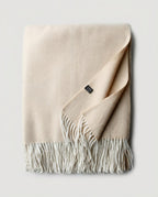 Macro close-up of the herringbone weave on cashmere-blend throw