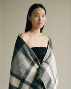 Wildfool nomad twill wool camp blanket in charcoal — full flat lay on a wooden deck