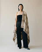 Two figures sharing the nomad wool blanket on a cold rooftop — lifestyle moment