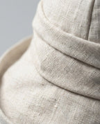 Macro close-up of the structured linen weave on Wildfool rolled-brim hat
