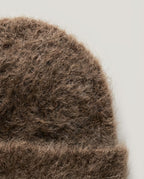 Suri alpaca cloud beanie in oat — back-of-head view with sweater context