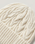 Back of head view — Wildfool cable-knit wool beanie on model in winter coat