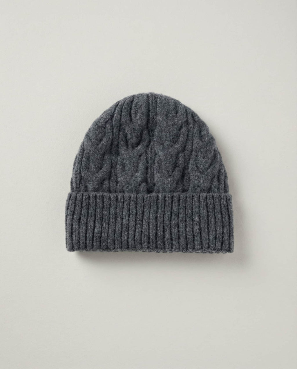 Side profile of Wildfool cable-knit beanie showing the slouchy crown