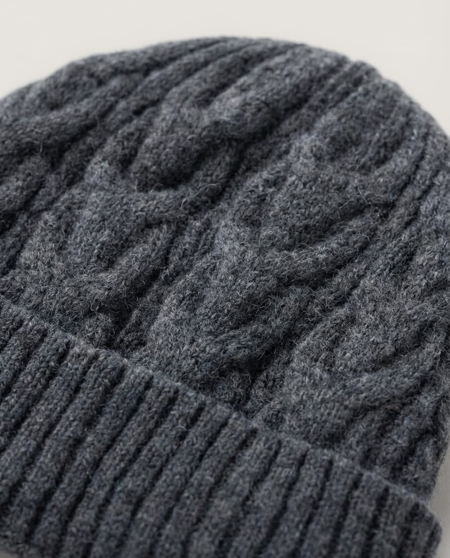 Macro close-up of the cable-knit twist pattern on 100% sheep wool