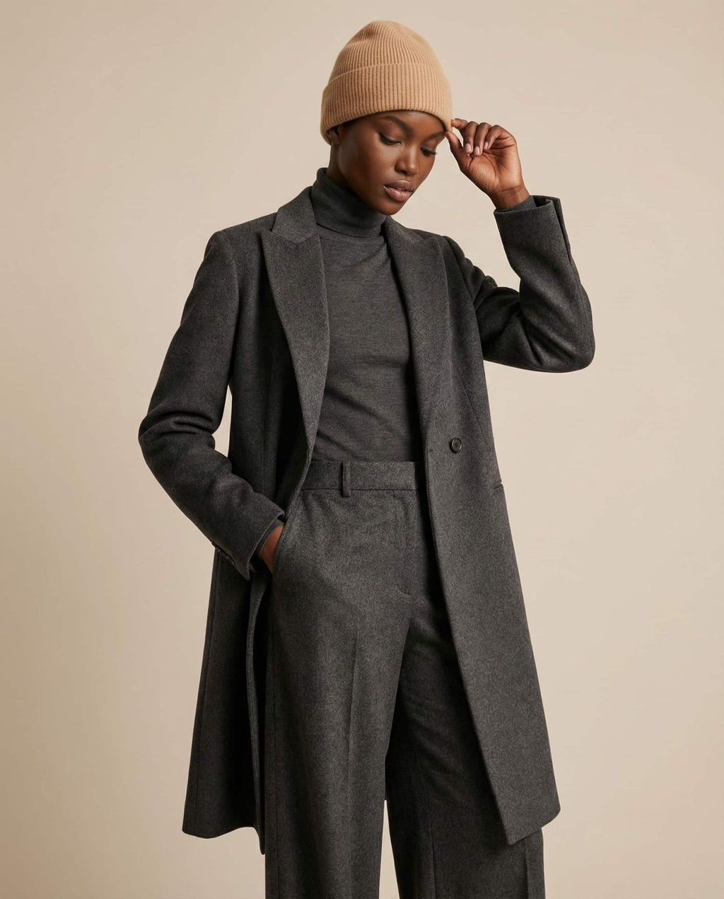 Alashan cashmere-blend beanie on a wooden coat hook — entryway lifestyle shot