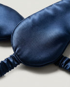 22-momme mulberry silk sleep mask worn on model — three-quarter view, eyes covered, calm expression