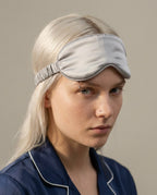 Wildfool silk sleep mask folded inside its drawstring travel pouch