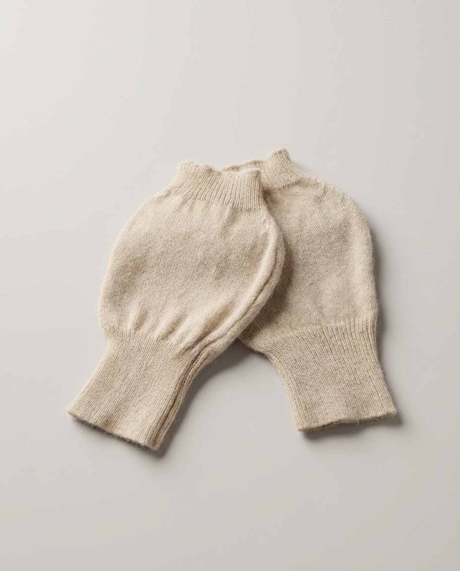 Cashmere fingerless gloves worn while typing on a laptop — lifestyle desk shot