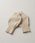 Cashmere fingerless gloves worn while typing on a laptop — lifestyle desk shot