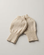 Cashmere fingerless gloves worn while typing on a laptop — lifestyle desk shot