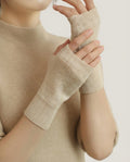Wildfool 100% Alashan cashmere fingerless gloves in natural undyed — overhead flat lay on linen
