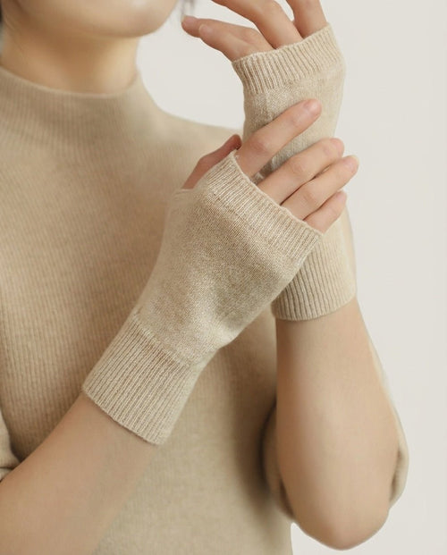 Wildfool 100% Alashan cashmere fingerless gloves in natural undyed — overhead flat lay on linen