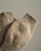 Wildfool cashmere fingerless gloves folded beside a notebook — still life
